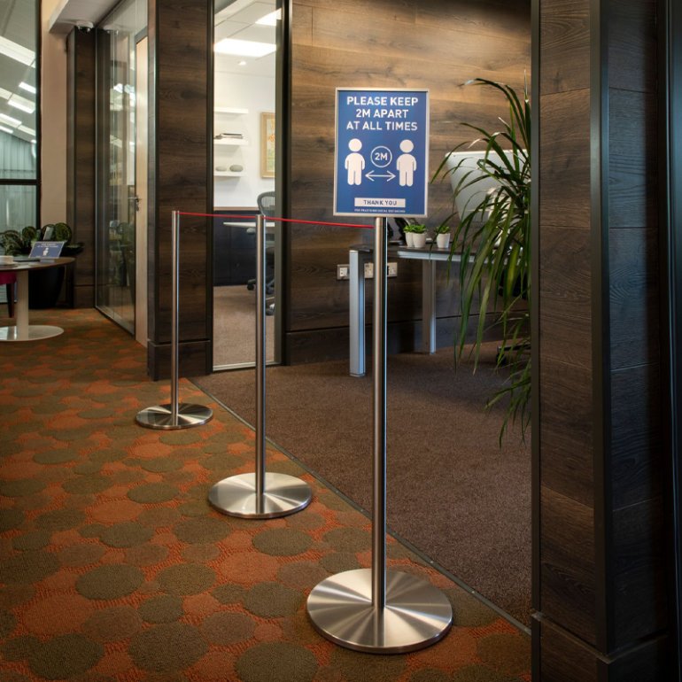 Absolute Freestanding Barriers in an office environment adapted to carry information signage about social distancing. Absolute Freestanding Barriers in an office environment adapted to carry information signage about social distancing.